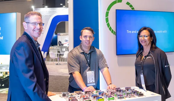 1stMILE team members with partners at a trade show booth