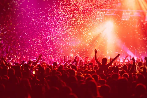Concert crowd with confetti and stage lights